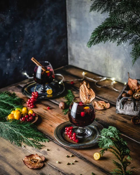 anasonlu şarap, kahverengi ahşap masada meyveli narenciye ve Noel süslemeli şarap.