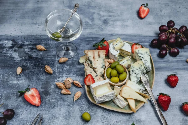 Plate Set Cheese Strawberries Olives Martini Glass Grunge Background — Stock Photo, Image