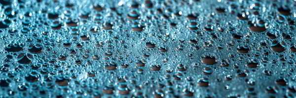 Modern banner with shiny drops of water on a blue background, abstract rainy wallpaper — Stock Photo, Image