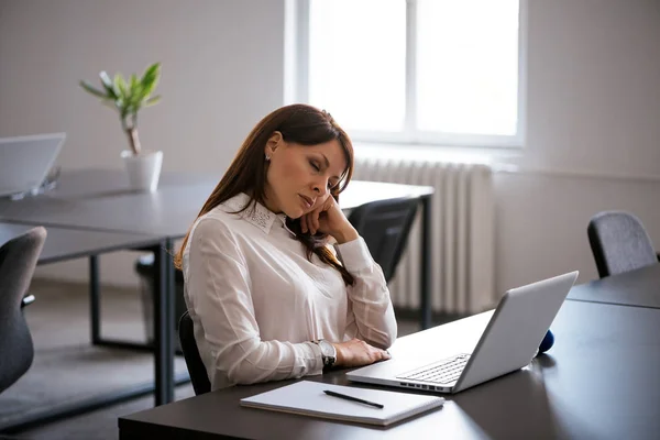 Kvinna på kontoret arbetar med bärbar dator — Stockfoto