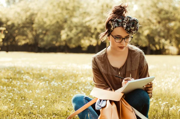 Girl on nature writing — Stock Photo, Image