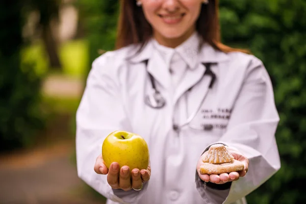 Doctor in park showing food