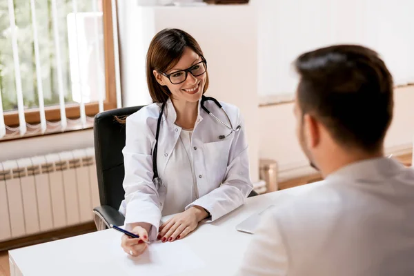 Patient consulting with doctor in hospital