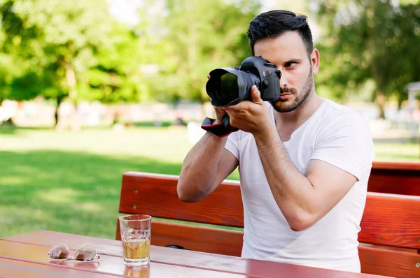 Attractive man with camera — Stock Photo, Image