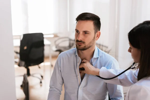 Patient consulting with doctor in hospital