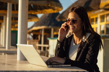 Laptop ile çalışan güneş gözlüklü kız 