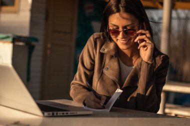 Laptop ile çalışan güneş gözlüklü kız 