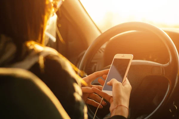 Female driver using smartphone