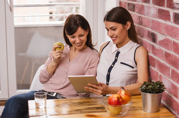 stock image Female friends using tablet