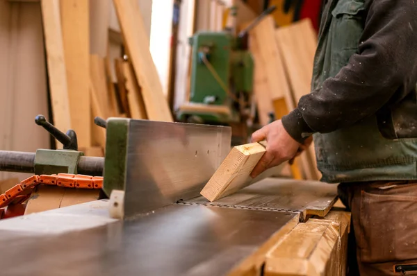 Marangoz tahtayla çalışıyor. 