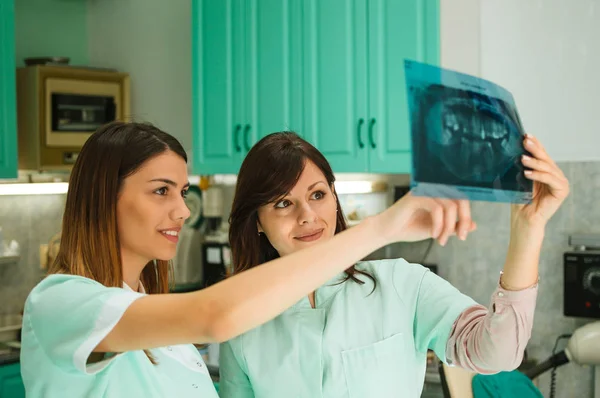 Dentista examinando paciente de rayos X — Foto de Stock