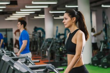 Koşu bandı üzerinde yürüyen insanlar  