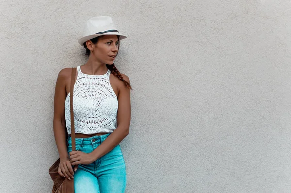 Woman standing against wall