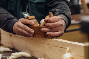 Marangoz tahtayla çalışıyor. 