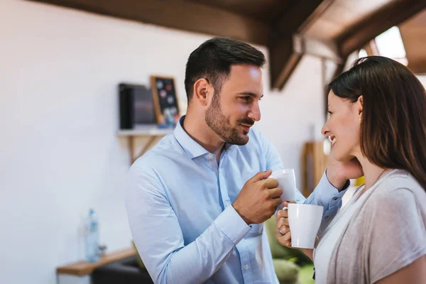 Couple relaxing at home with coffee — Stock Photo, Image