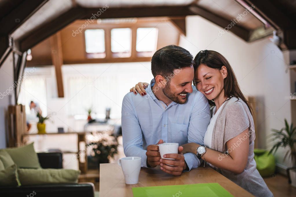 Couple relaxing at home with coffee 