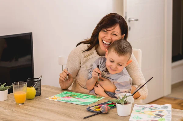 Mother painting with son