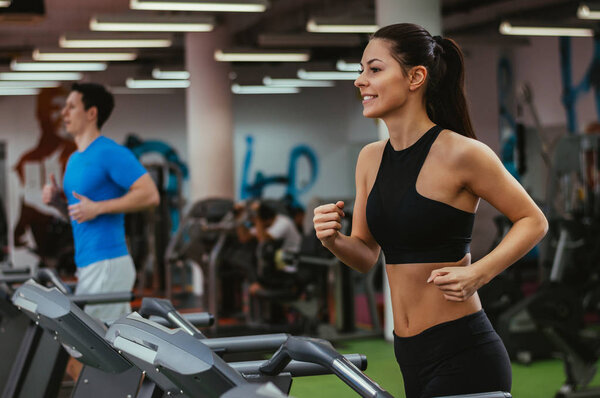 Girl running on treadmill in gym