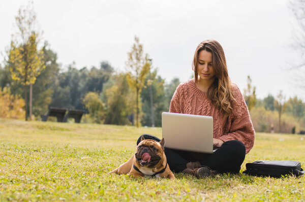 girl working  with french bulldog