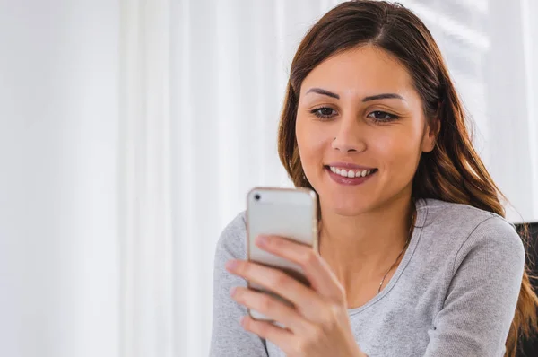 Menina curiosa olhando para seu telefone — Fotografia de Stock