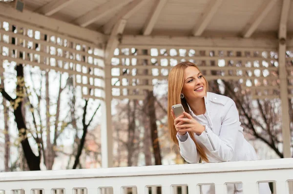 Woman outdoors texting Stock Picture
