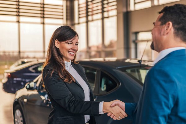  car dealer handshake with customer