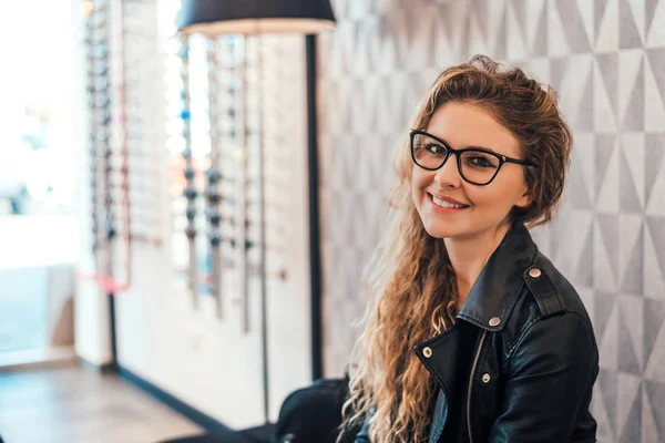 Young woman in optical store. — Stock Photo, Image