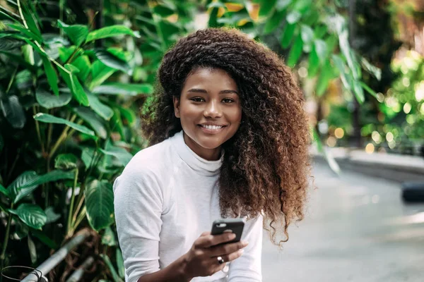 Portrait of young woman with curly hair — Stock Photo, Image