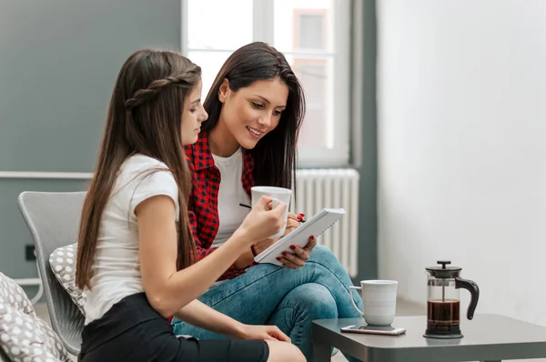 businesswomen discussing a report