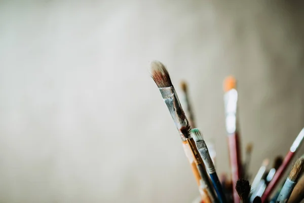 Close up of paint brushes on blurred background