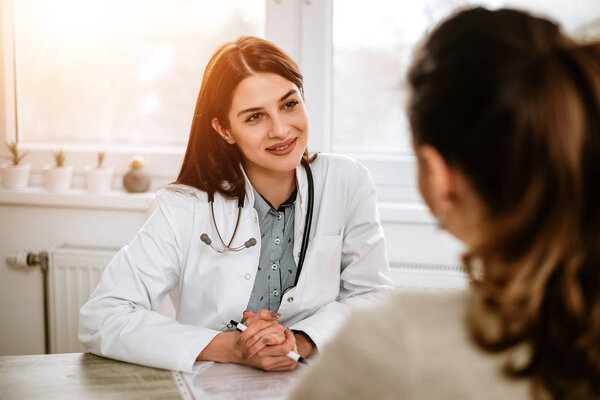 female doctor listening patient on consultation
