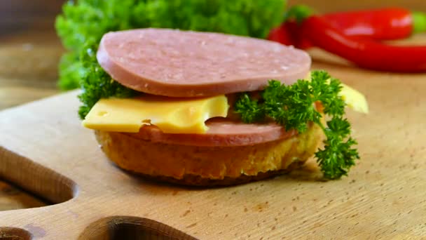 Appetizing Sandwich Prepared Cutting Board Bun Salad Parsley Sausage Cheese — Stock Video