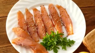 Somon fileto kesme tahtası ve yayılan bir plaka üzerinde kesti. Lezzetli somon fileto baharatlar ile serpilir. Yağlı Norveç balık. Omega 3