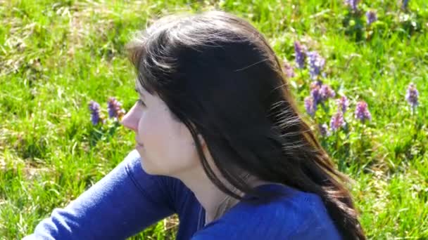 Beautiful Girl Relaxes Lawn Sitting Grass Blue Flowers Girl Resting — Stock Video