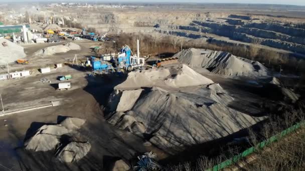 Cantera de granito. Empresa minera de granito piedra. La vista desde la altura de la cantera. Una excavadora está cargando un camión con piedra . — Vídeo de stock