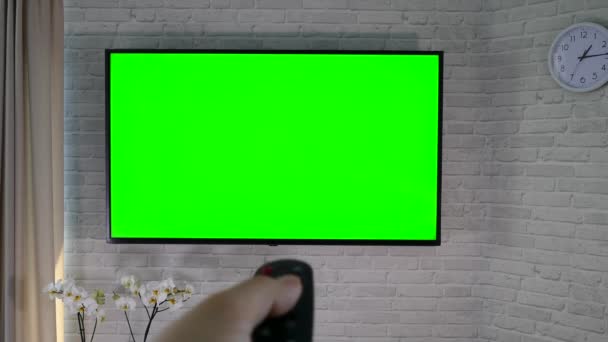 Watching Remote Control Hand Green Screen Brick Wall Living Room — Stock Video