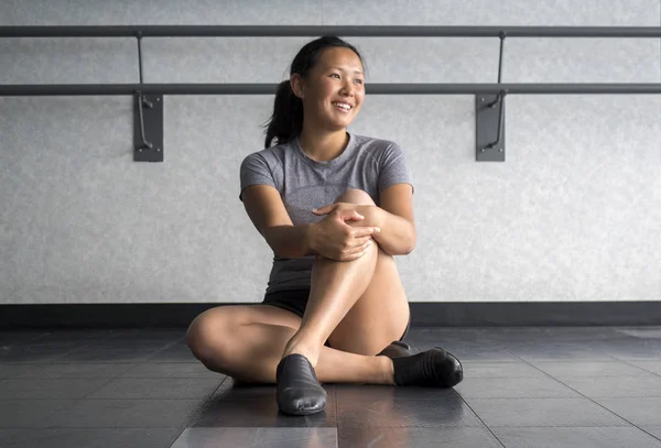 Smiling jazz dancer in jazz class listening to her teach