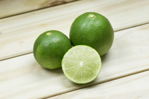 Fresh green limes with half — Stock Photo, Image