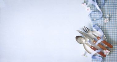 Damalı peçete üzerinde uçan daire ile çatal bıçak takımı