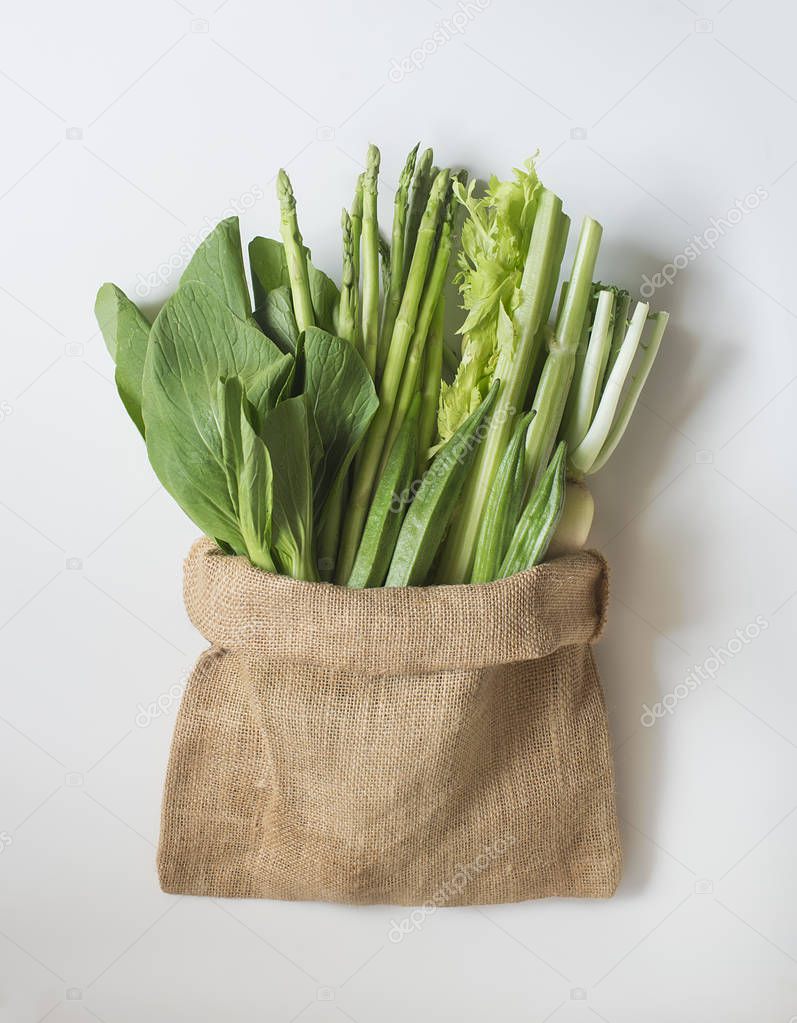 different green herbs in fabric bag