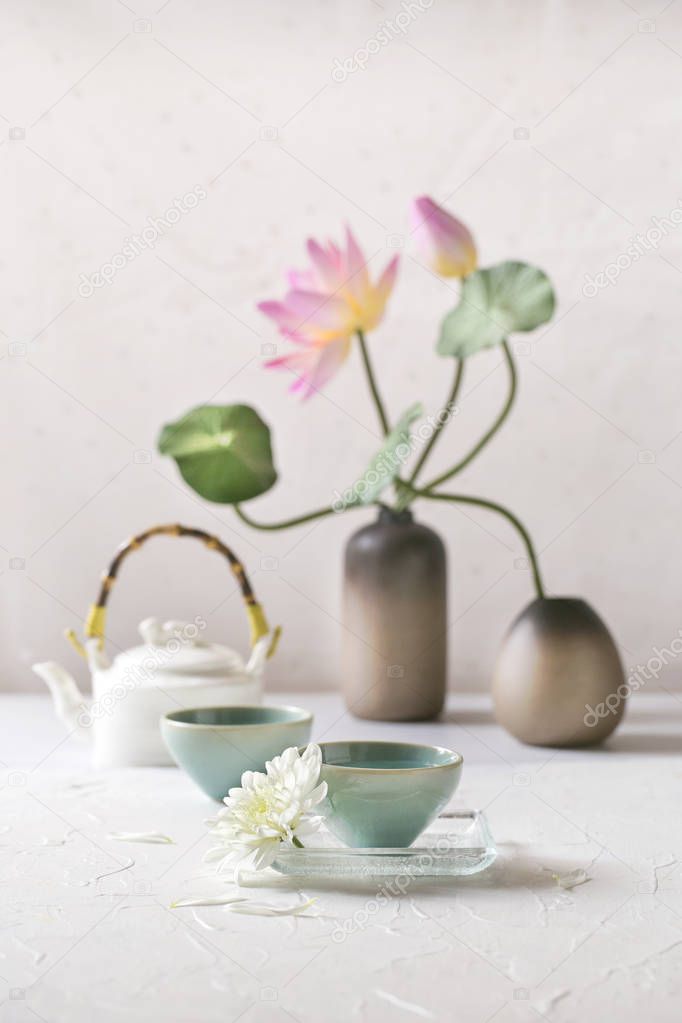 Chinese tea set on white table top with decorative items. Selective focus image.