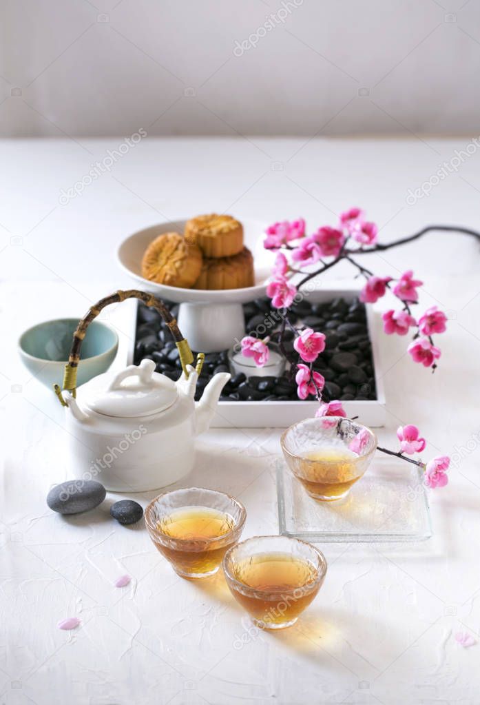 Afternoon Chinese tea with snack on white table top.