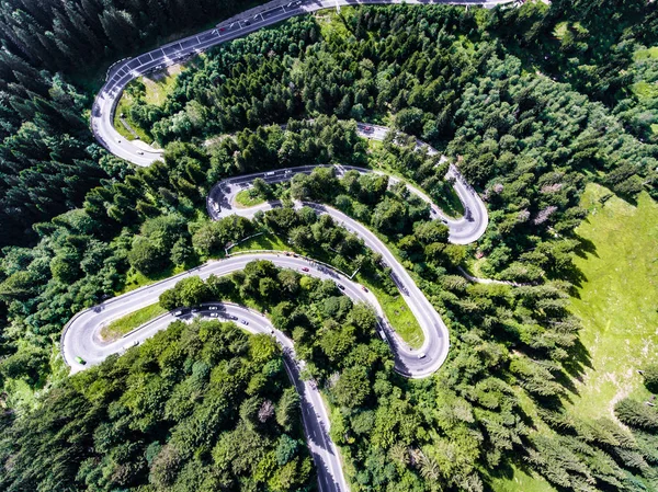 Coches en el camino sinuoso a través de la vista aérea del bosque —  Fotos de Stock