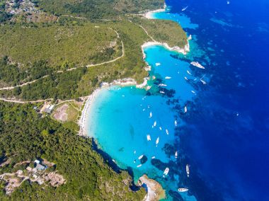 Antipaxos Island, Greece, with sandy beach, people swimming and  clipart