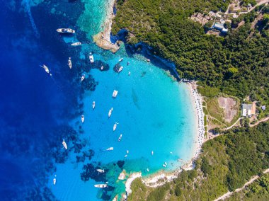 Antipaxos Island, Greece, with sandy beach, people swimming and  clipart