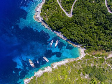 People swimming in the clear blue waters of Antipaxos Island, ne clipart
