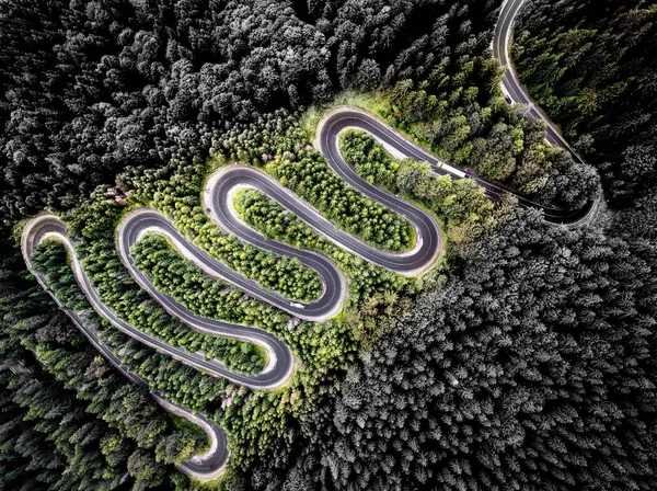 Aerial view of a winding road in the forest. Artistic interpreta — Stock Photo, Image