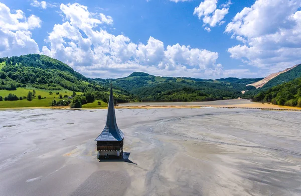 Geamana Lake and flooded Church near Rosia Montana Romania