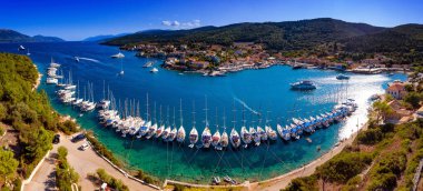 Yachts ancored in harbour in Fiskardo Kefalonya bay in Greece clipart