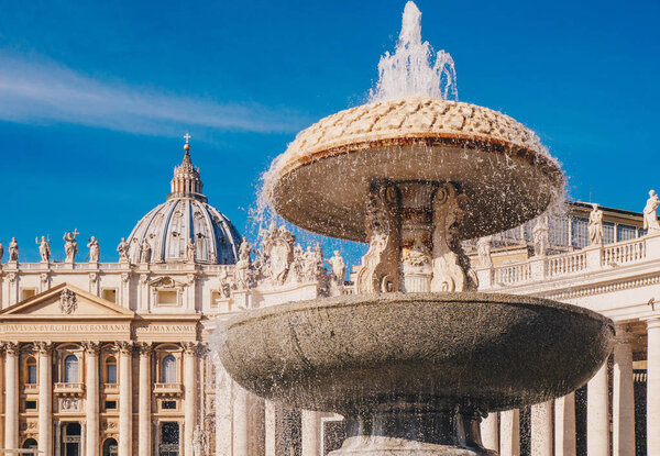 Saint Peter's Basilica and the fountain in front in Vatican, Rom